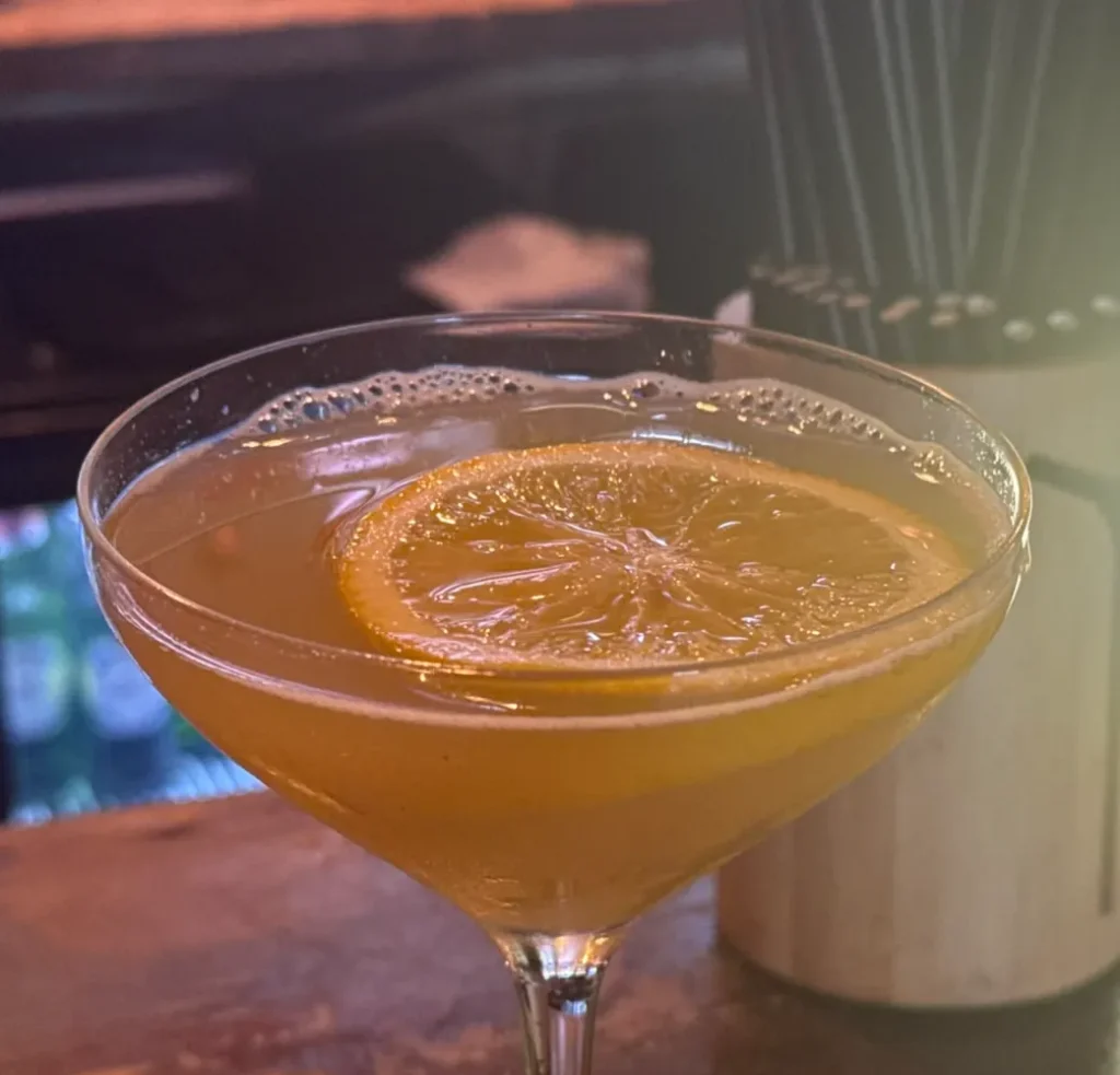 A Shed signature cocktail garnished with orange