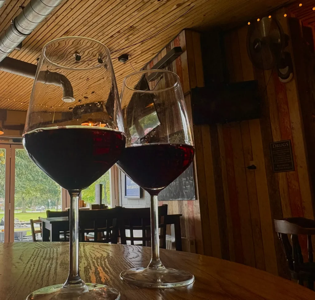 Two glasses of red wine on a table at The Shed