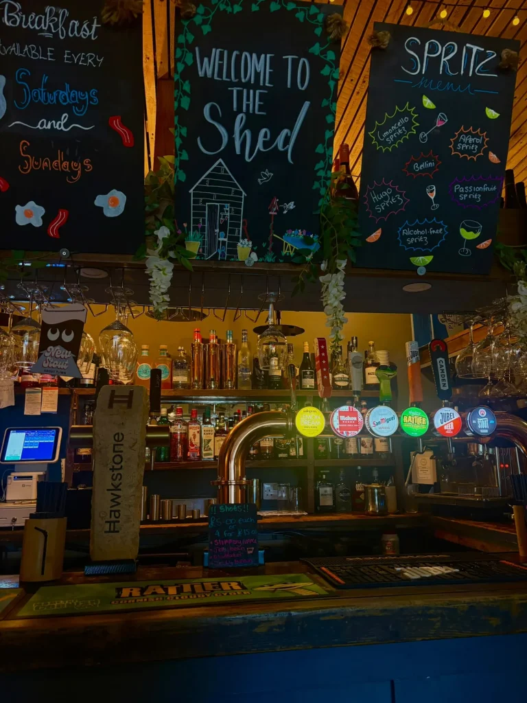 The bar at The Shed with chalkboards and taps